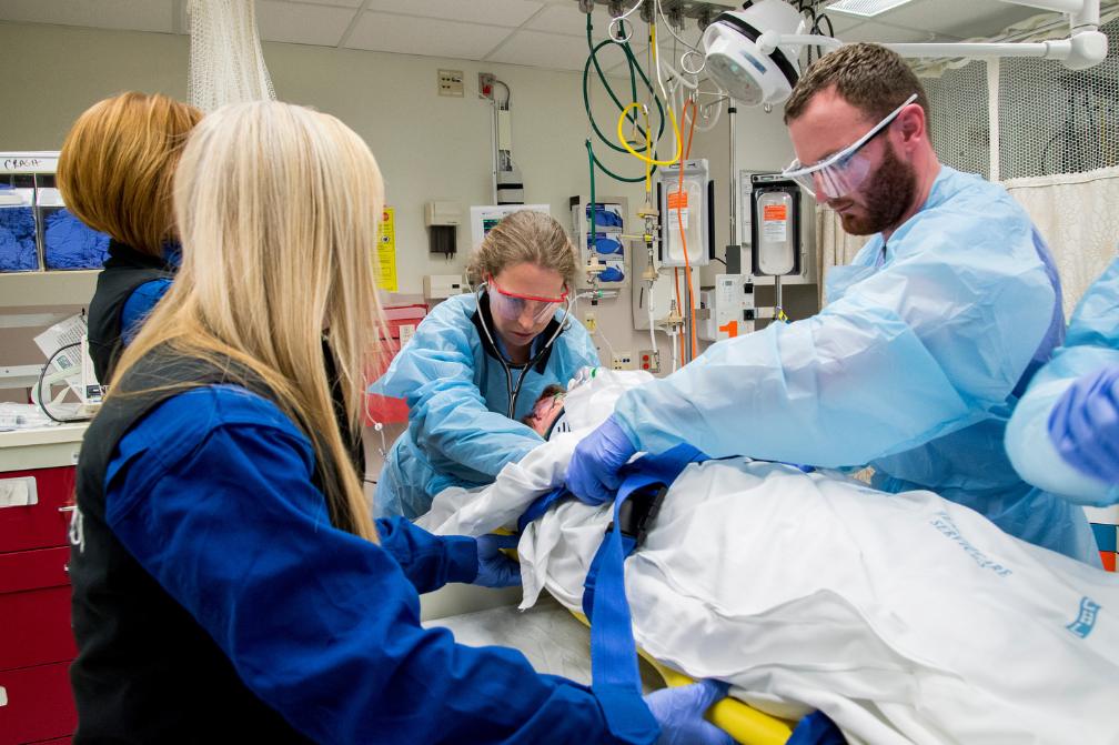 Emergency department personnel work on a patient.